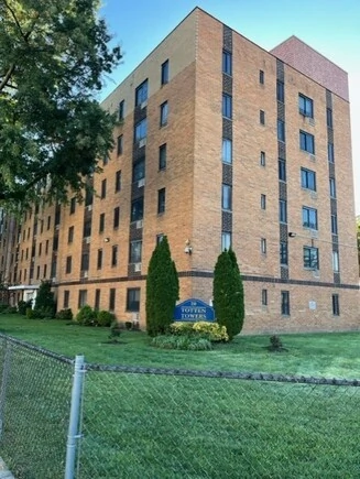 General Douglas Mac Arthur Senior Village sign at the entrance of a brick building.