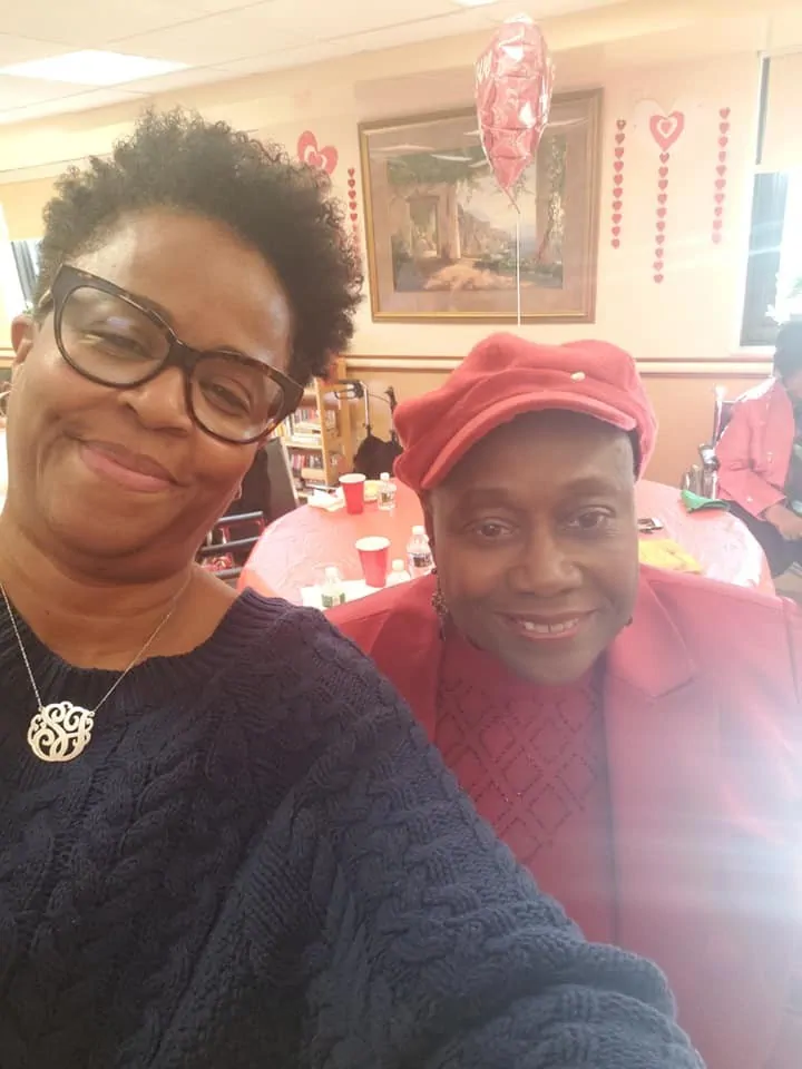 Group selfie at a community event, featuring two smiling people.