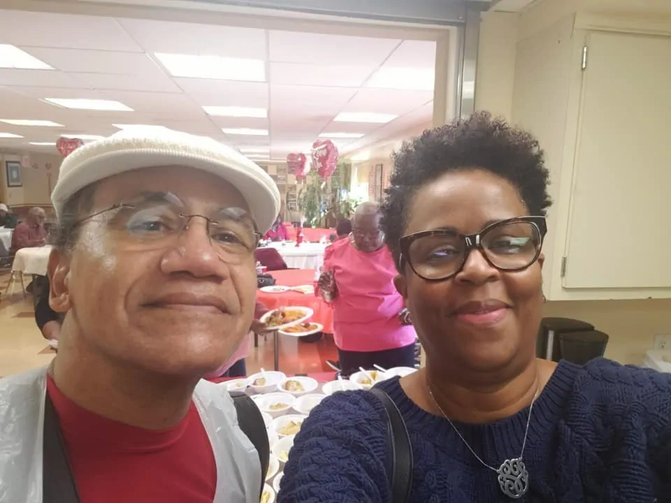Two smiling women wearing glasses pose for a selfie.